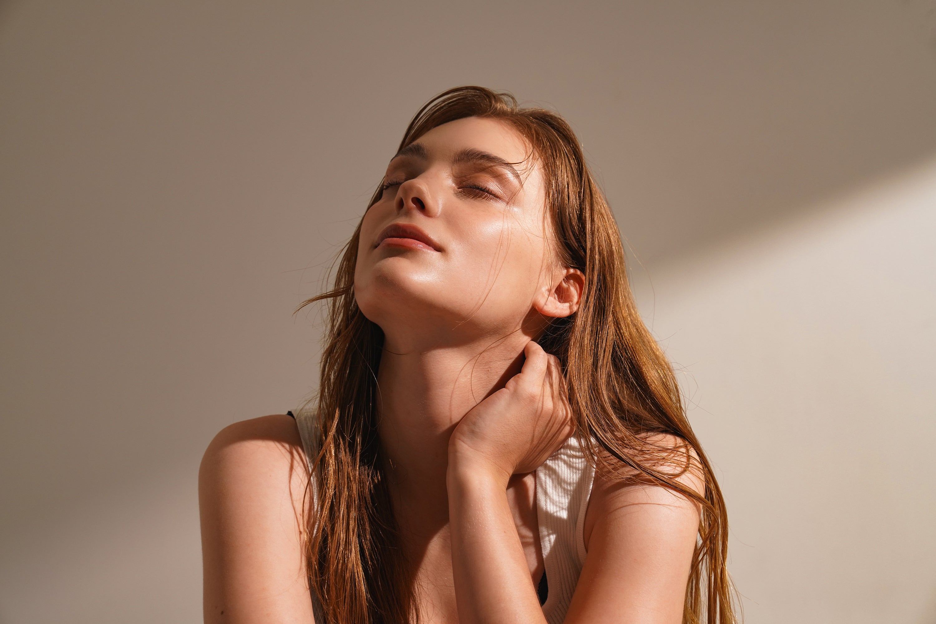 Woman with closed eyes and long hair.
